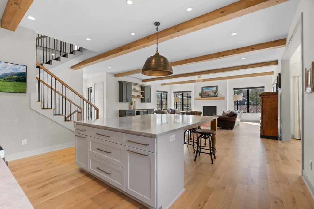 Modern open-concept kitchen and living room with beams