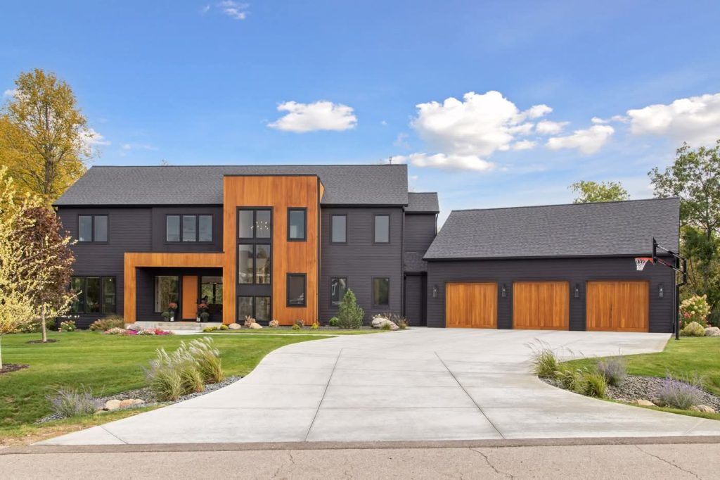 Modern two-story home with wood accents and garage
