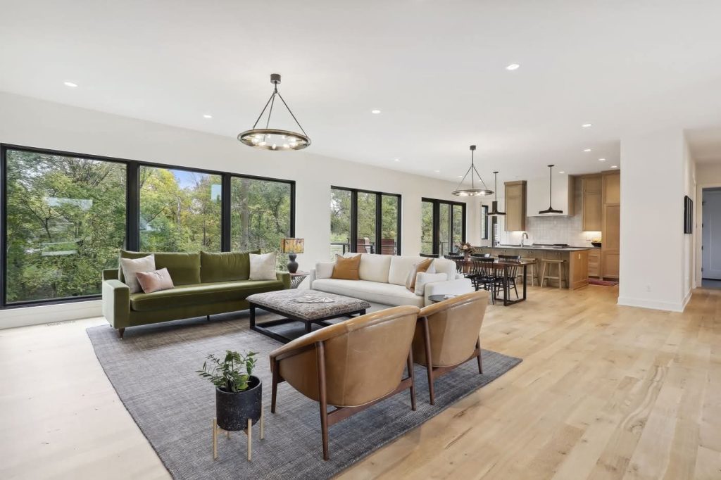 Modern open-concept living room and kitchen with large windows