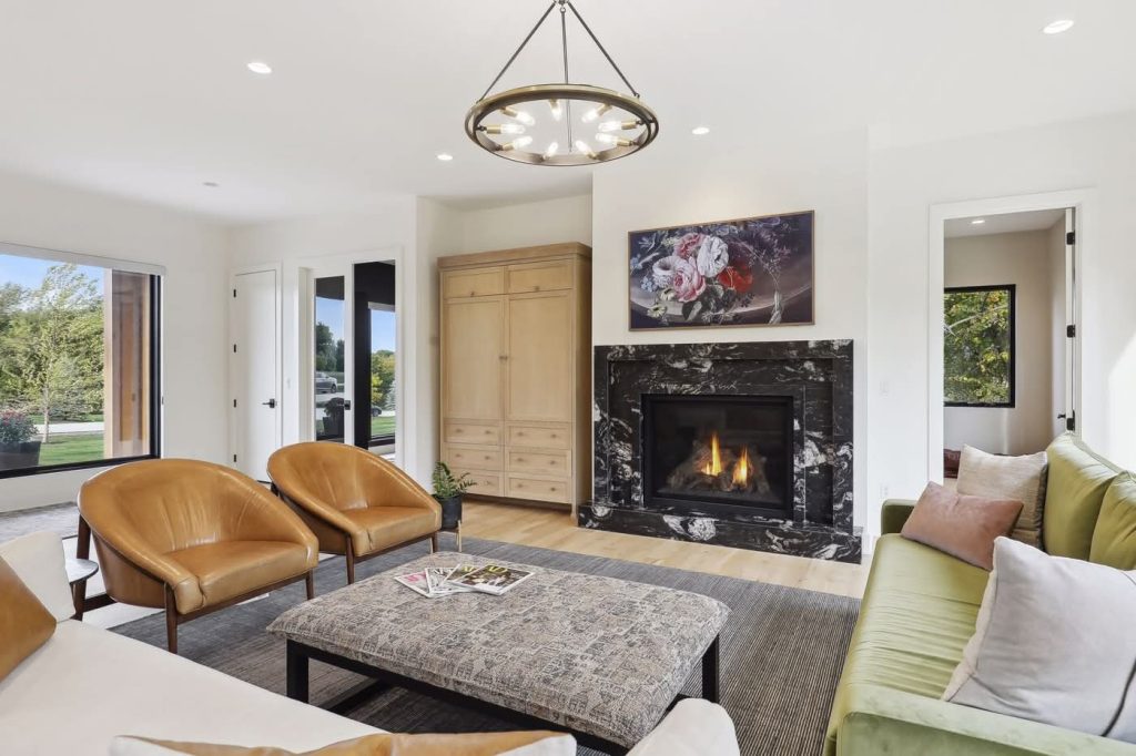 Modern living room with marble fireplace and leather chairs