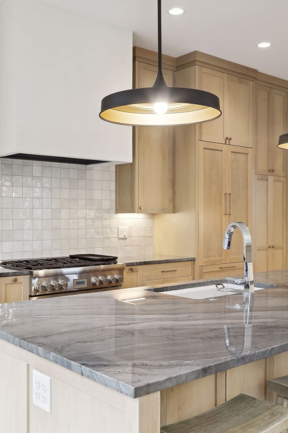 Modern kitchen with marble island and pendant lighting