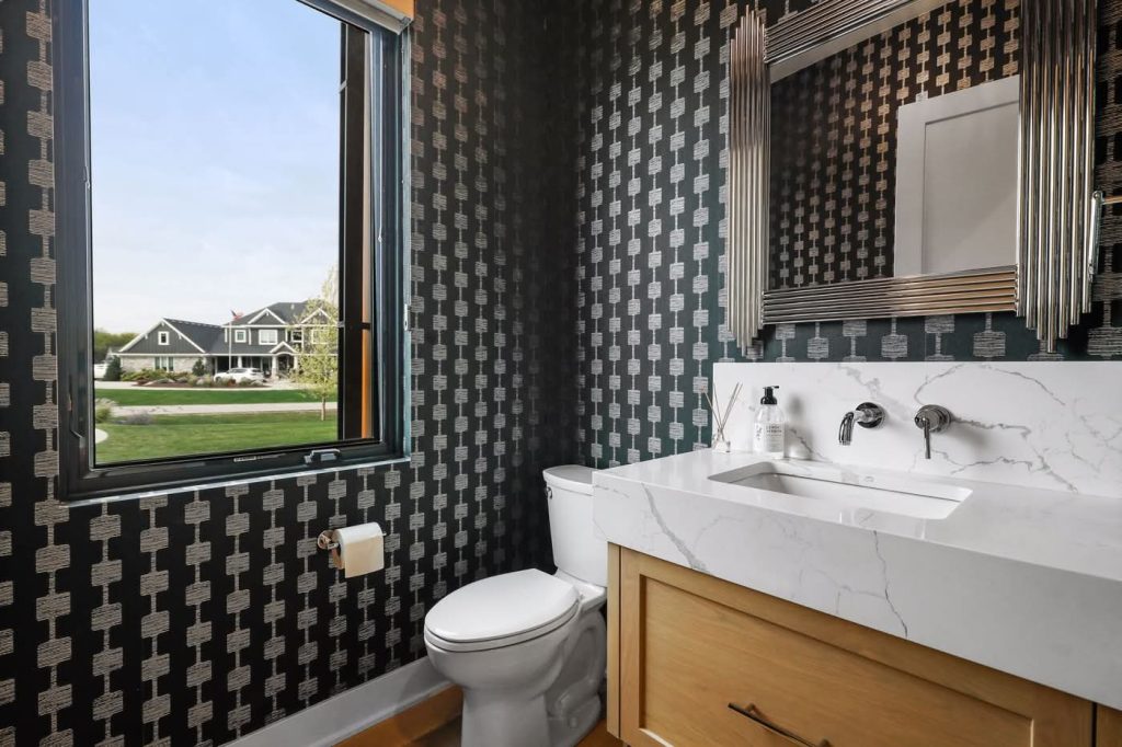 Modern bathroom with patterned wallpaper and window