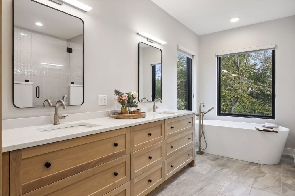 Modern bathroom with double vanity and freestanding tub