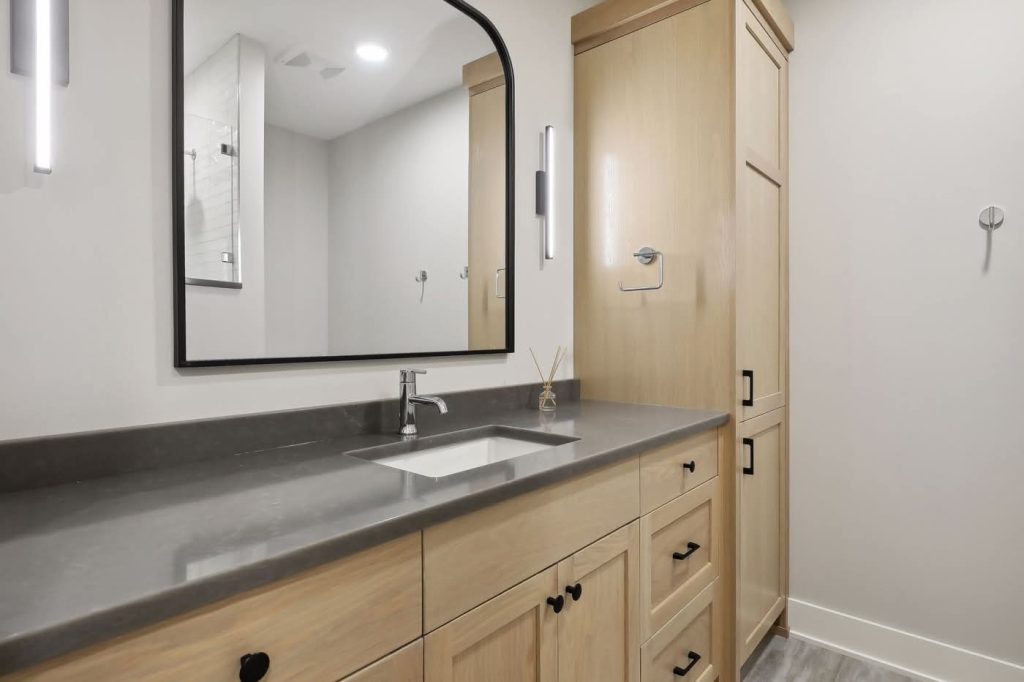 Modern bathroom vanity with wood cabinets and mirror