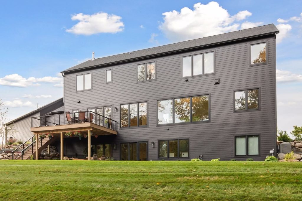 Modern gray house with deck and large windows