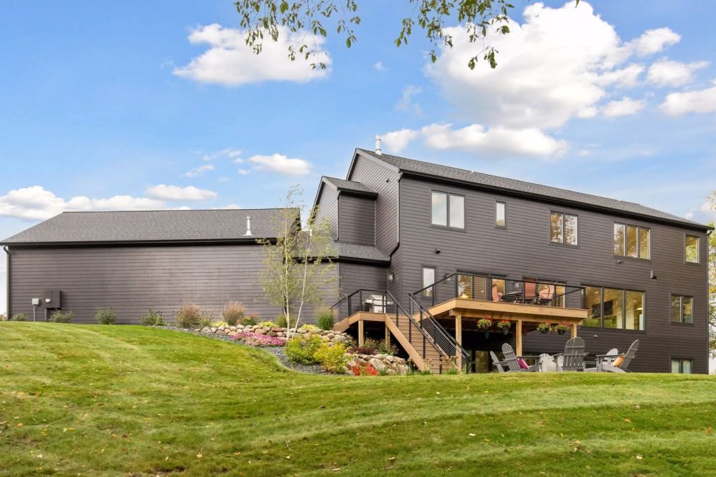 Modern two-story home with elevated deck and lawn