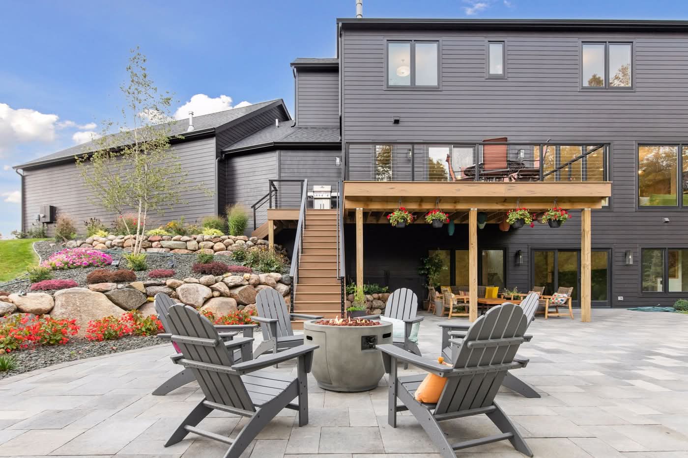 Modern backyard patio with fire pit and deck