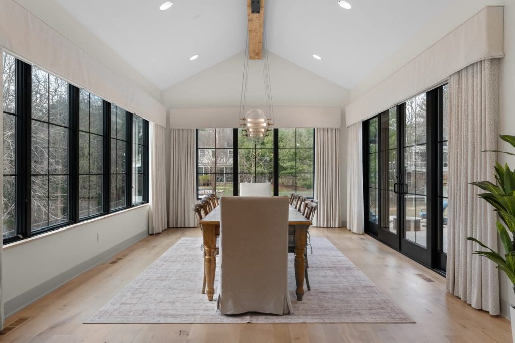 Modern dining room with large windows and wooden table