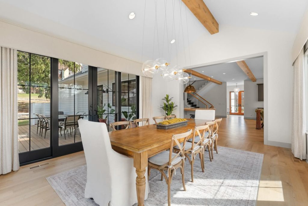 Modern dining room with wooden table and glass doors
