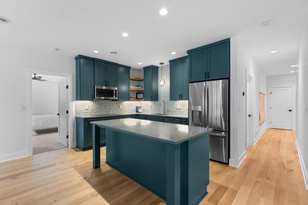 Modern kitchen with teal cabinets and island