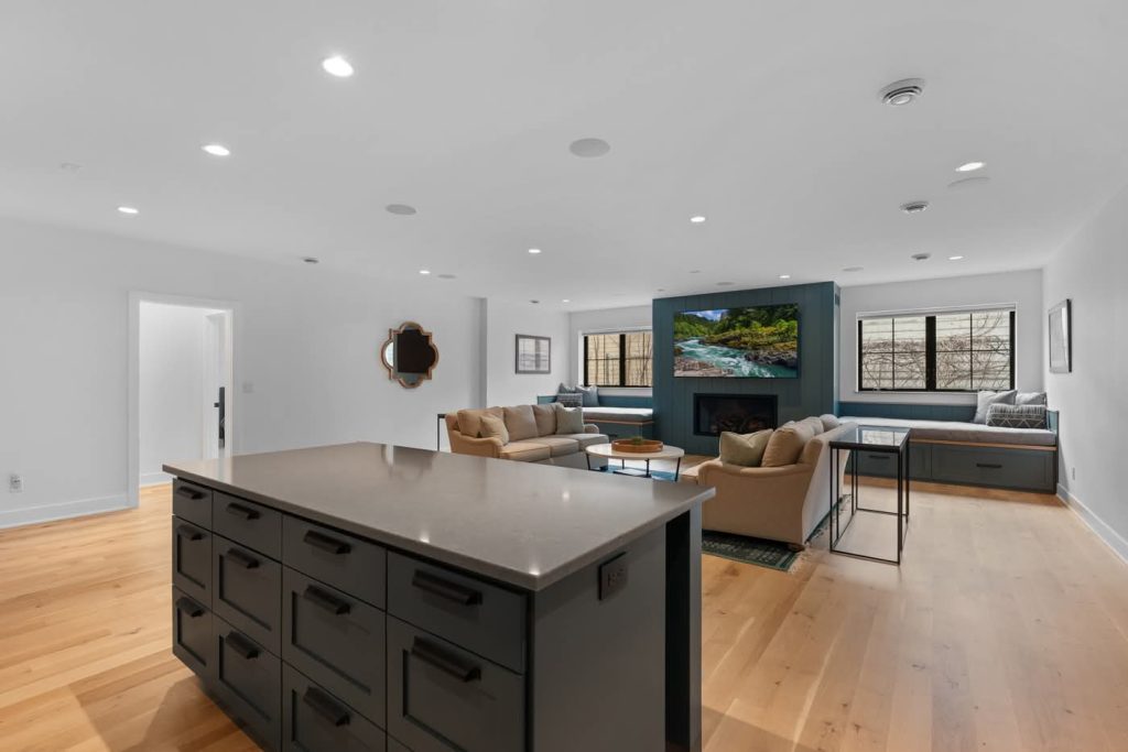 Modern open-concept living room with kitchen island and fireplace