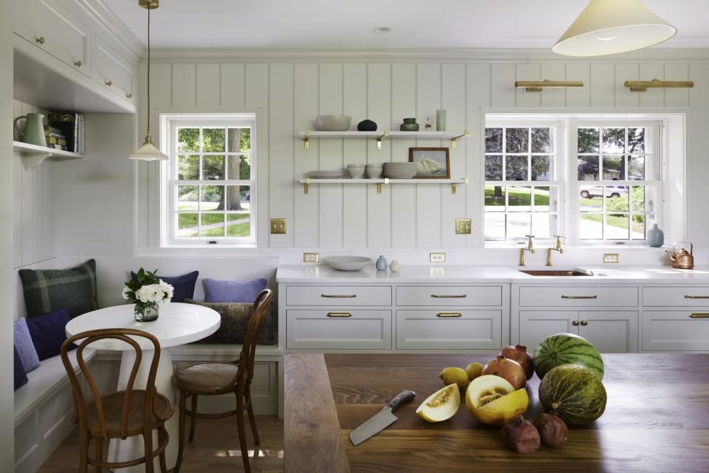 Bright modern kitchen with wooden island and fruit