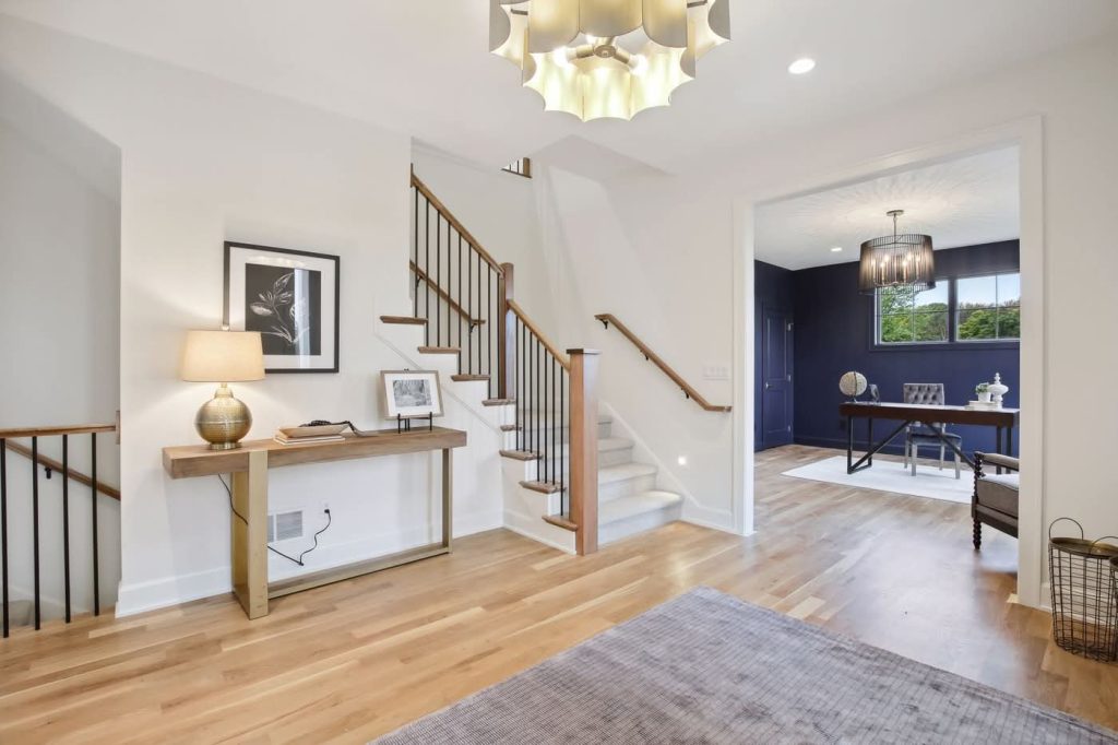 Modern entryway with staircase and adjacent home office