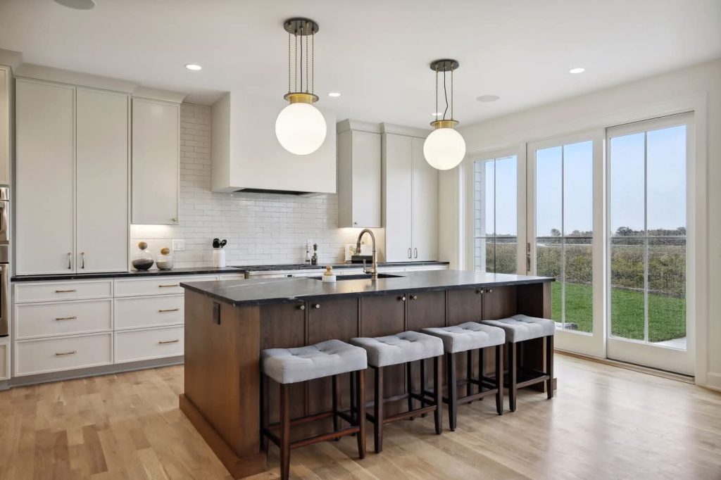 Modern kitchen with island, bar stools, large windows