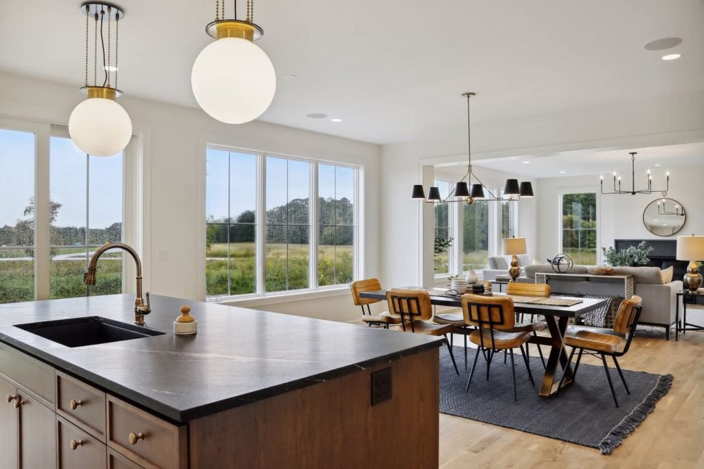Modern open-concept kitchen and dining area with large windows