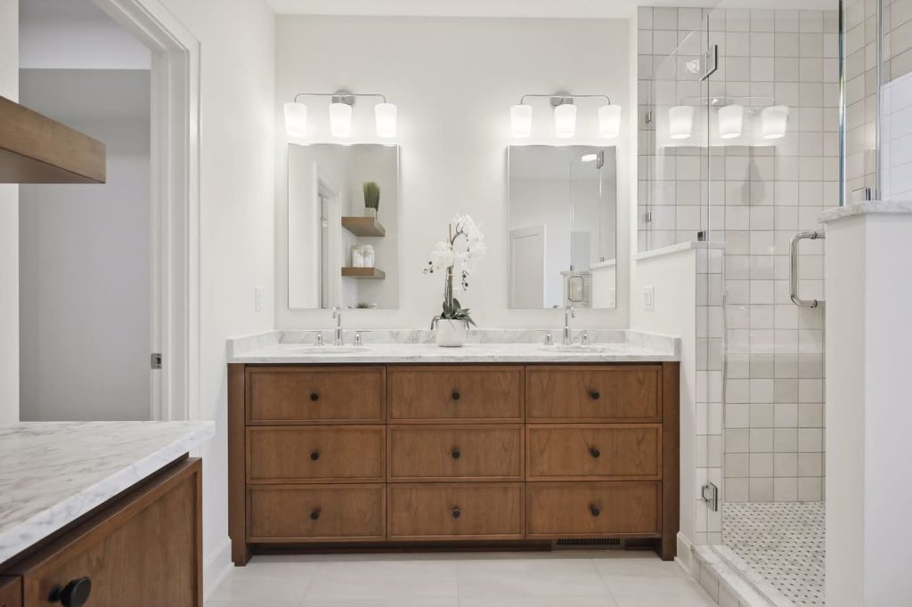 Modern bathroom with double vanity and glass shower
