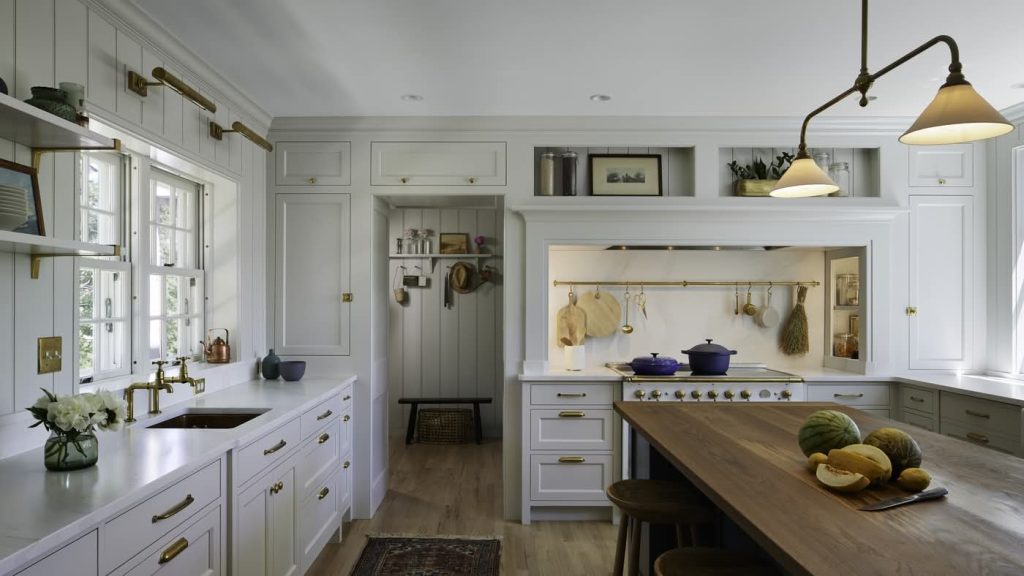 Bright white farmhouse kitchen with wooden island