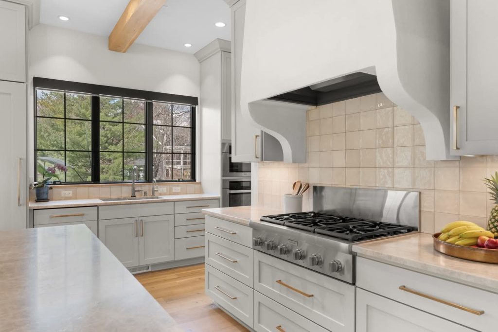 Modern white kitchen with large window and gas range