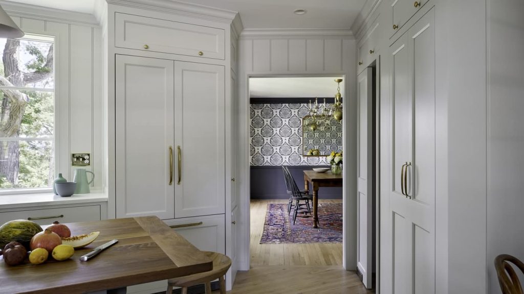 Bright white kitchen with view into patterned dining room