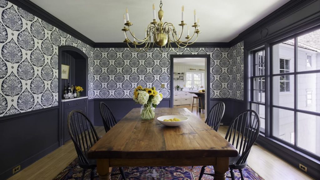 Elegant dining room with patterned wallpaper and chandelier