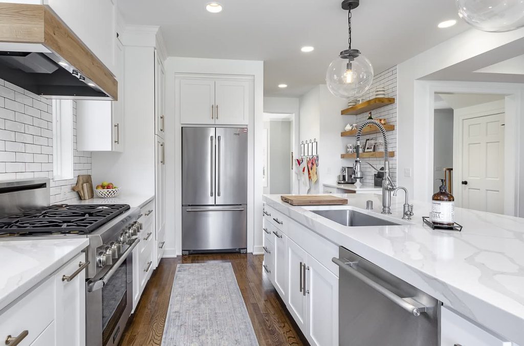 Modern white kitchen with island and stainless appliances