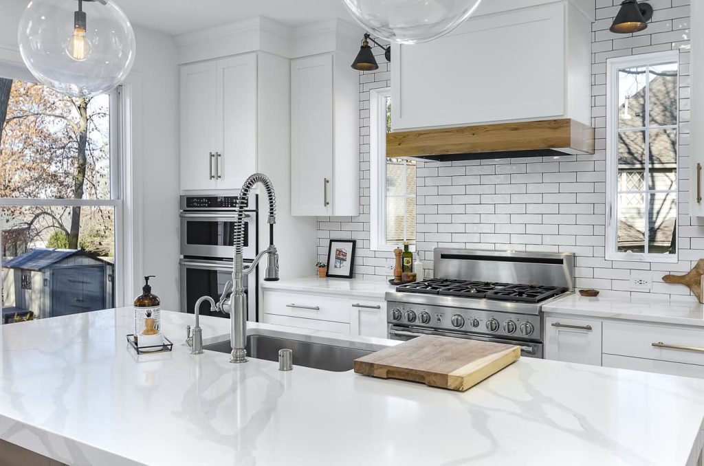 Modern white kitchen with island and stainless range