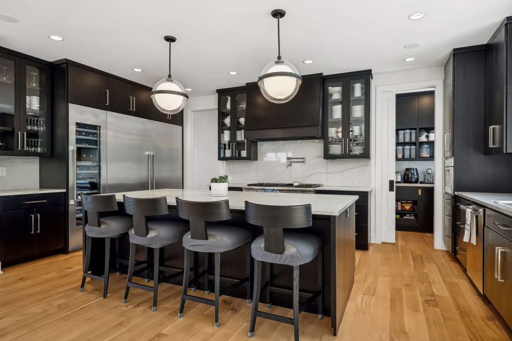 Modern kitchen with dark cabinets and white island