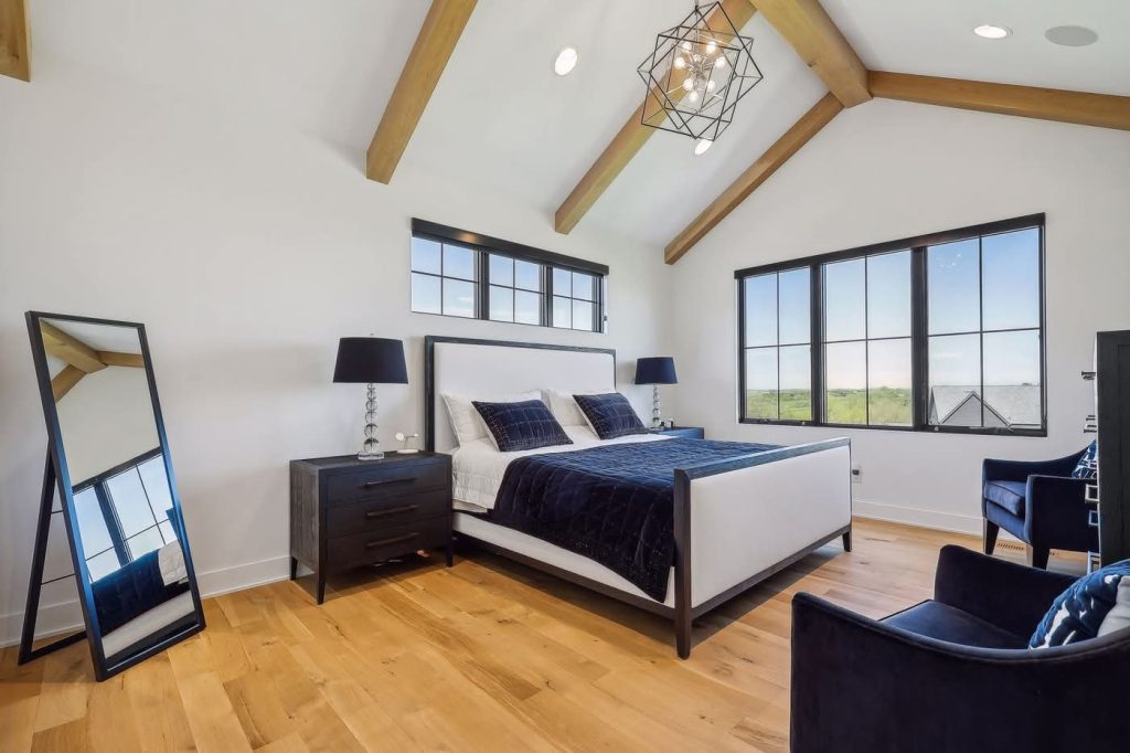 Modern bedroom with exposed beams and large windows