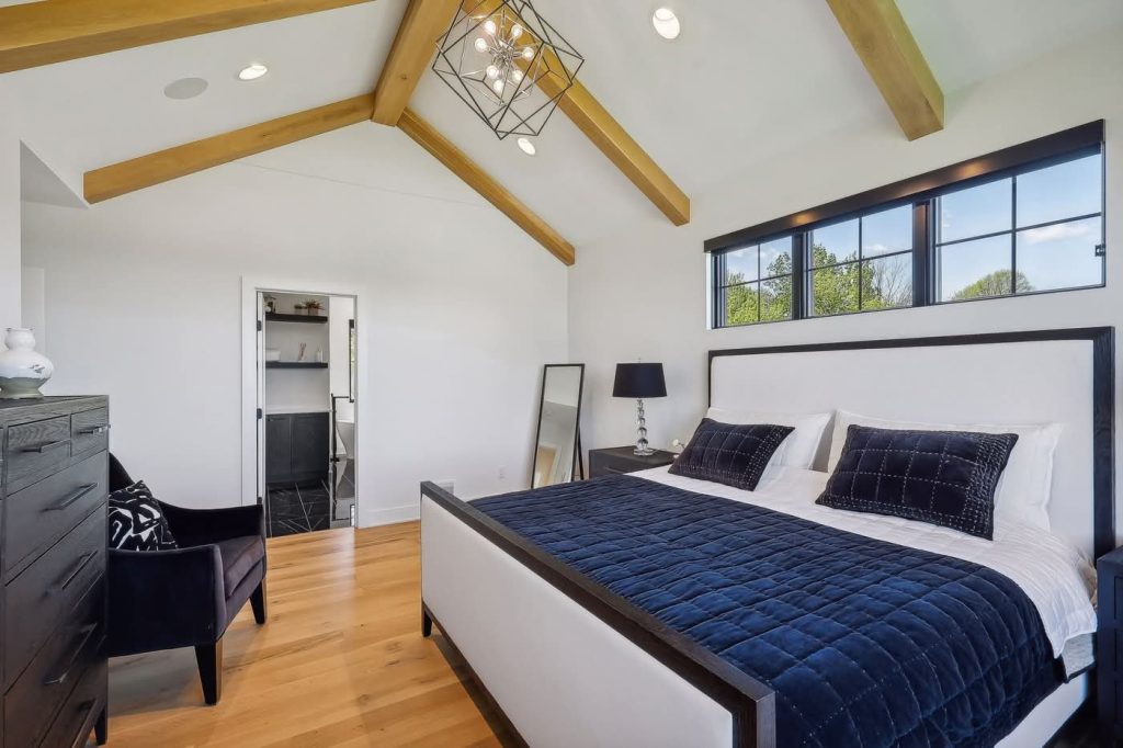 Modern bedroom with vaulted ceiling and wood beams