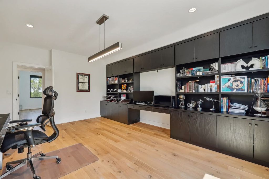 Modern home office with black built-in cabinets