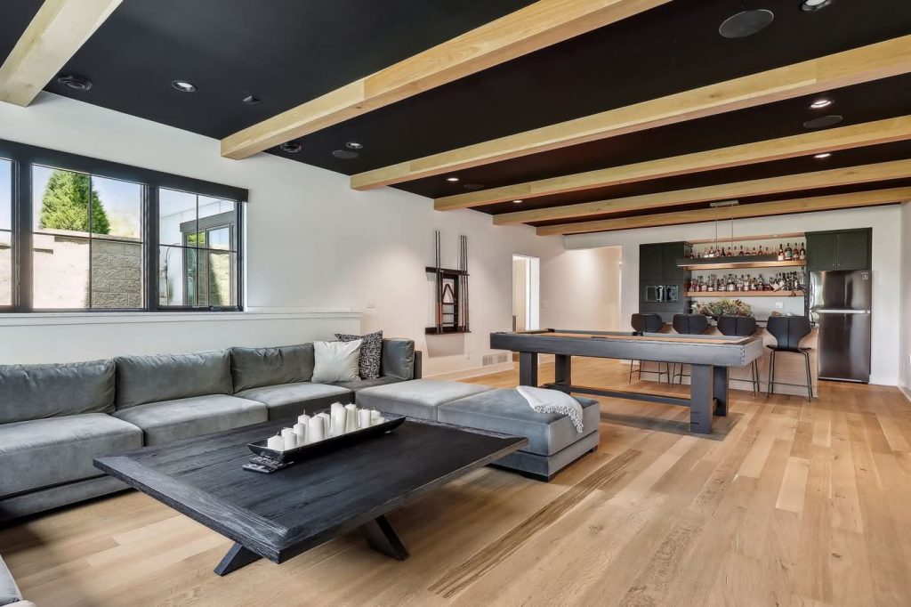 Modern living room with bar and shuffleboard table
