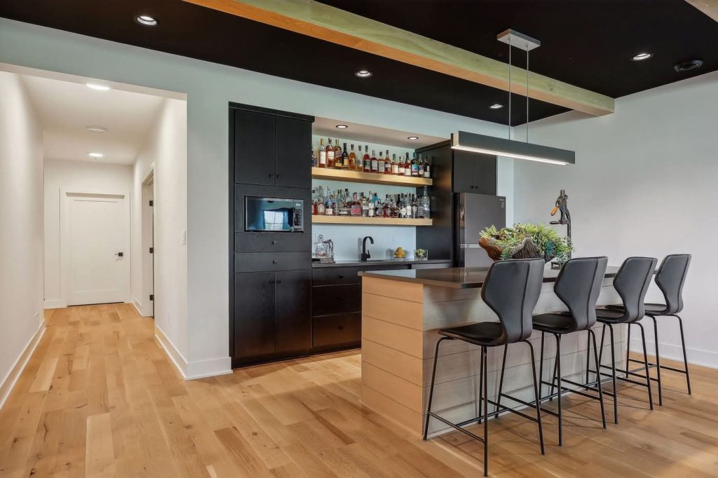 Modern home bar with island and black cabinets