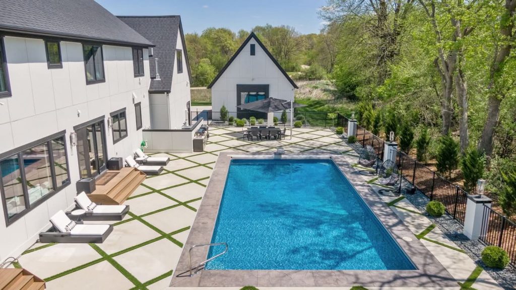 Modern backyard with rectangular pool and patio seating
