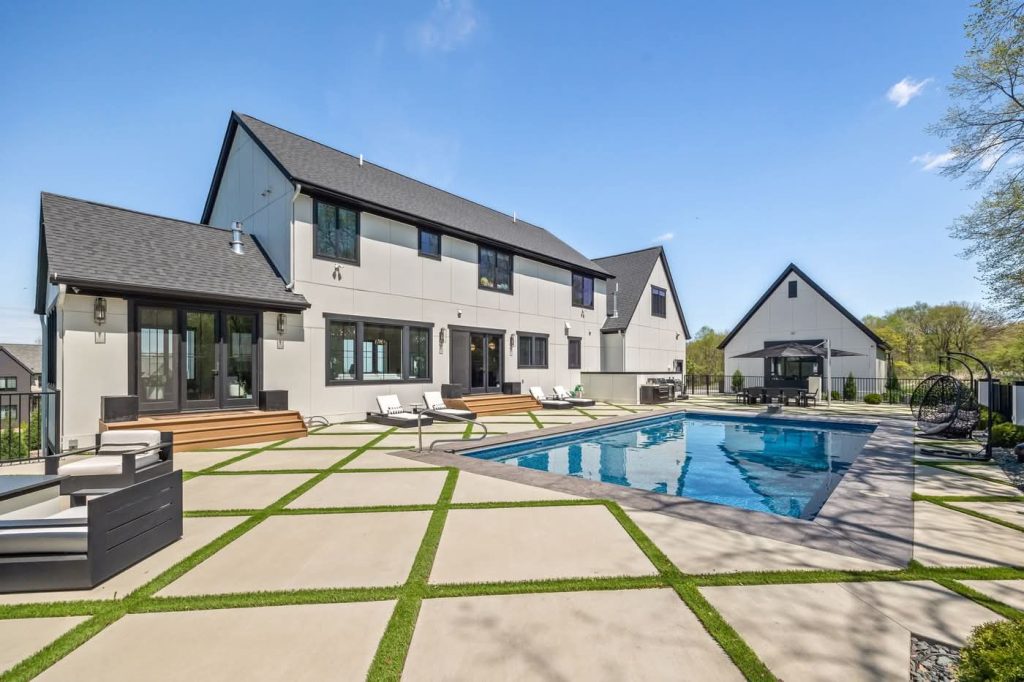Modern home with backyard pool and patio
